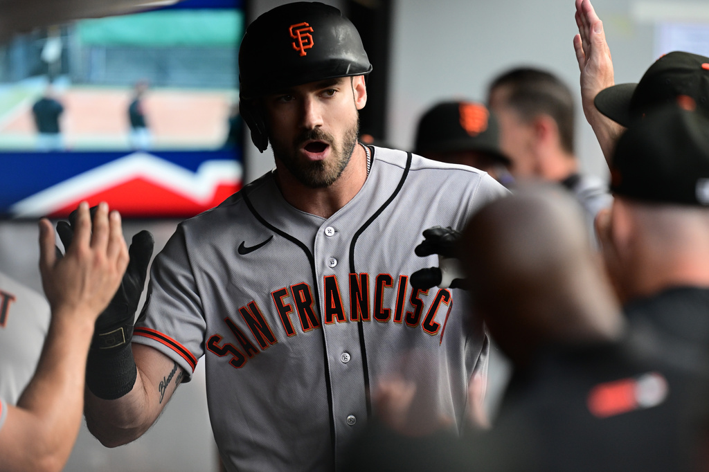 San Francisco Giants' Bryce Eldridge is congratulated in the dugout after hitting a solo home run off Cleveland Guardians starting pitcher Foster Griffin during the second inning of a baseball game, Tuesday, Aug. 18, 2026, in Cleveland. (AP Photo/David Dermer)