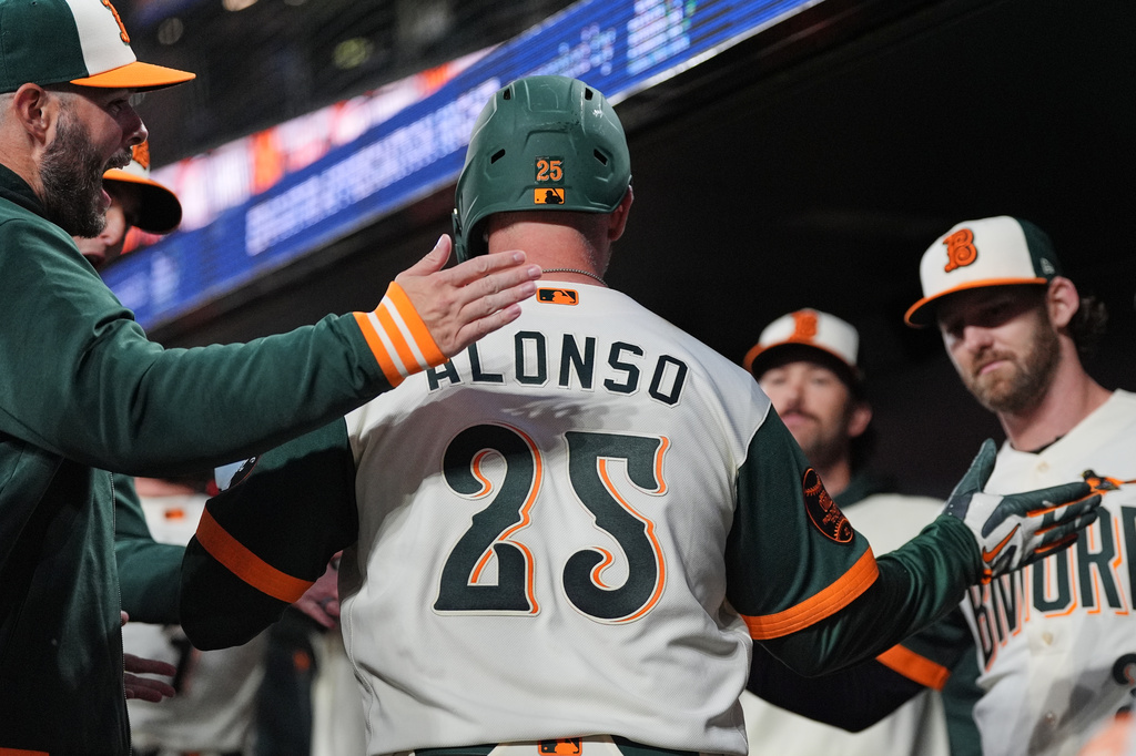 Baltimore Orioles' Pete Alonso (25) celebrates with teammates in the dugout after hitting a three-run home run during the third inning of a baseball game against the Detroit Tigers, Friday, May 22, 2026, in Baltimore. (AP Photo/Stephanie Scarbrough)
