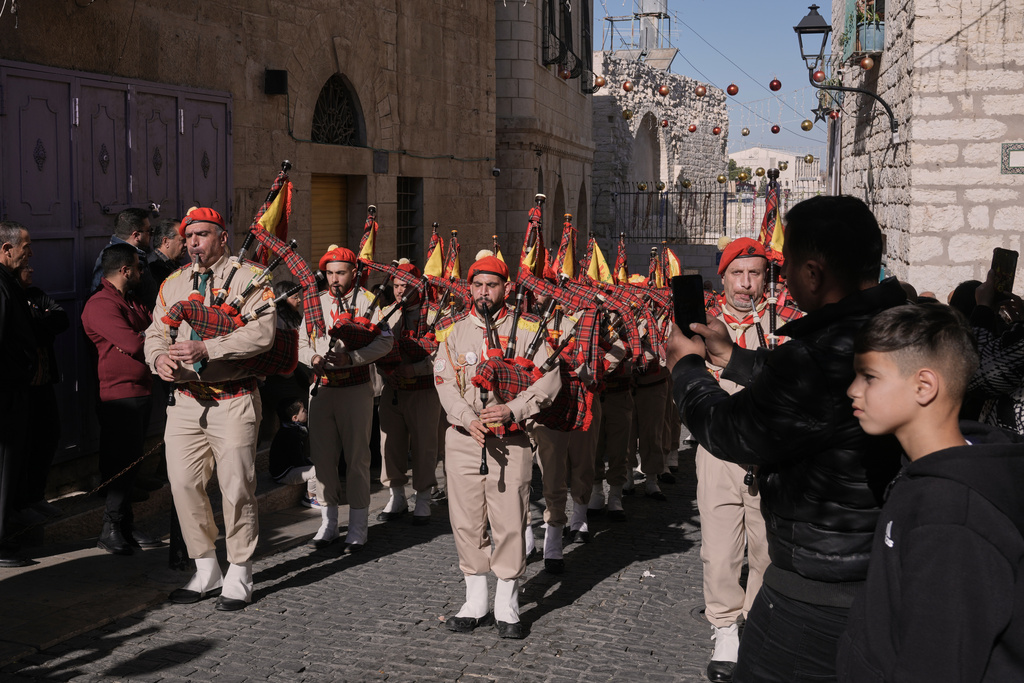 Palestinian scout bands parade toward the Manger Square near the Church of the Nativity, traditionally believed to be the birthplace of Jesus, on Christmas Eve, in the West Bank city of Bethlehem, Wednesday, Dec. 24, 2025. (AP Photo/Mahmoud Illean)