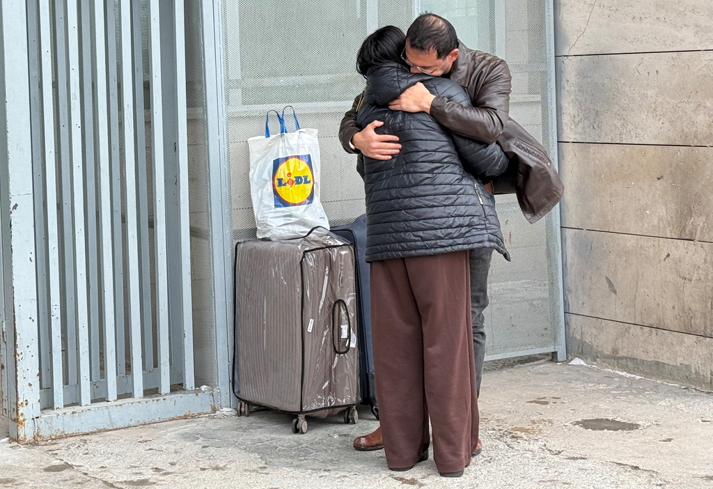 A man welcomes a woman who crossed from Iran to Turkey at the Kapikoy Border Gate in eastern Van province, Turkey, Thursday, March 5, 2026. (AP Photo/Serra Yedikardes)