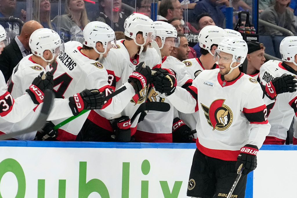 Ottawa Senators defenseman Artem Zub (2) celebrates with the bench after his goal against the Tampa Bay Lightning during the second period of an NHL hockey game Thursday, Oct. 9, 2025, in Tampa, Fla. (AP Photo/Chris O'Meara)