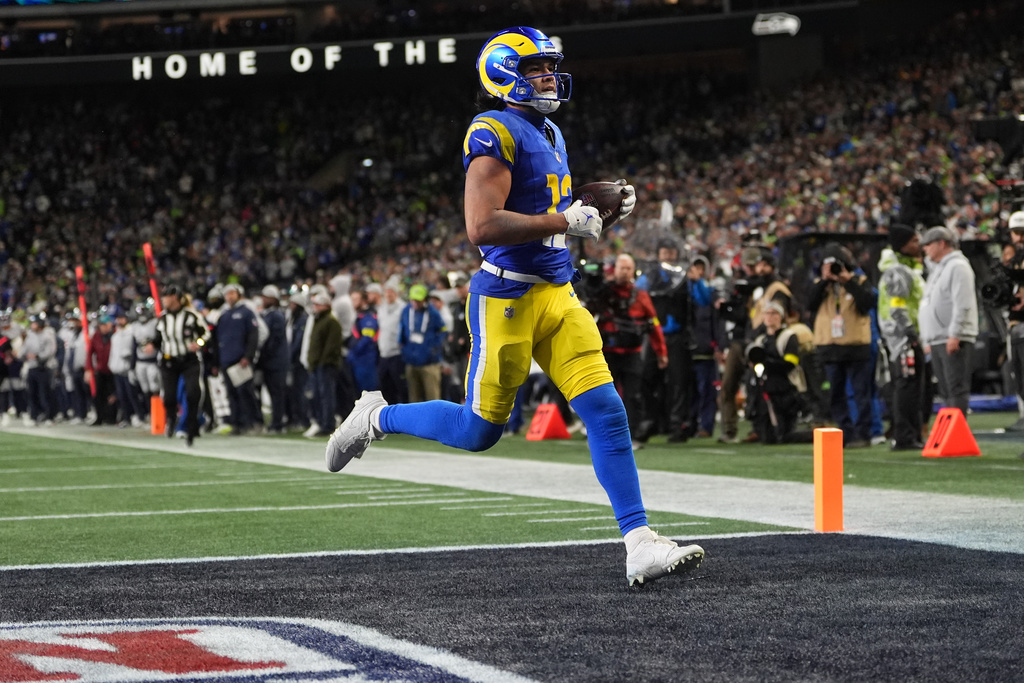 Los Angeles Rams wide receiver Puka Nacua scores a touchdown during overtime in an NFL football game against the Seattle Seahawks, Thursday, Dec. 18, 2025, in Seattle. (AP Photo/Lindsey Wasson)