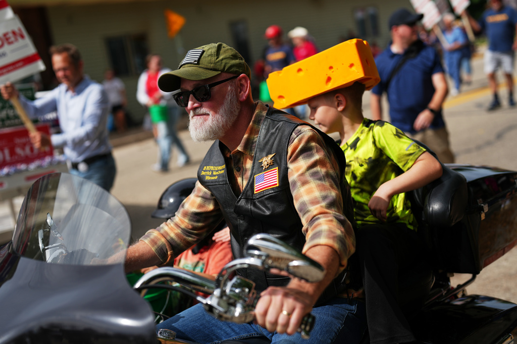 Rep. Derrick Van Orden, R-Wis., a candidate for Wisconsin's 3rd Congressional district, rides a motorcycle with his grandson in a Labor Day parade, Monday, Sept. 7, 2026, in Readstown, Wis. (AP Photo/Ellen Schmidt)
