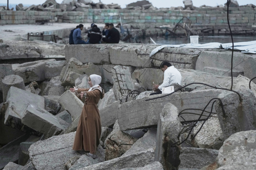 A Palestinian man and his fiancee take pictures on the Mediterranean Sea in the port of Gaza City, Saturday, Dec. 6, 2025. (AP Photo/Jehad Alshrafi)