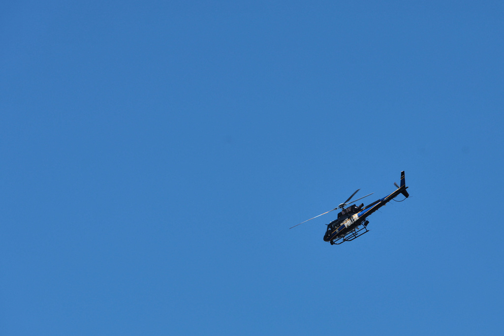A Baltimore Police helicopter flies above the scene of a shooting Tuesday, March 10, 2026, in Baltimore. (AP Photo/KT Kanazawich)