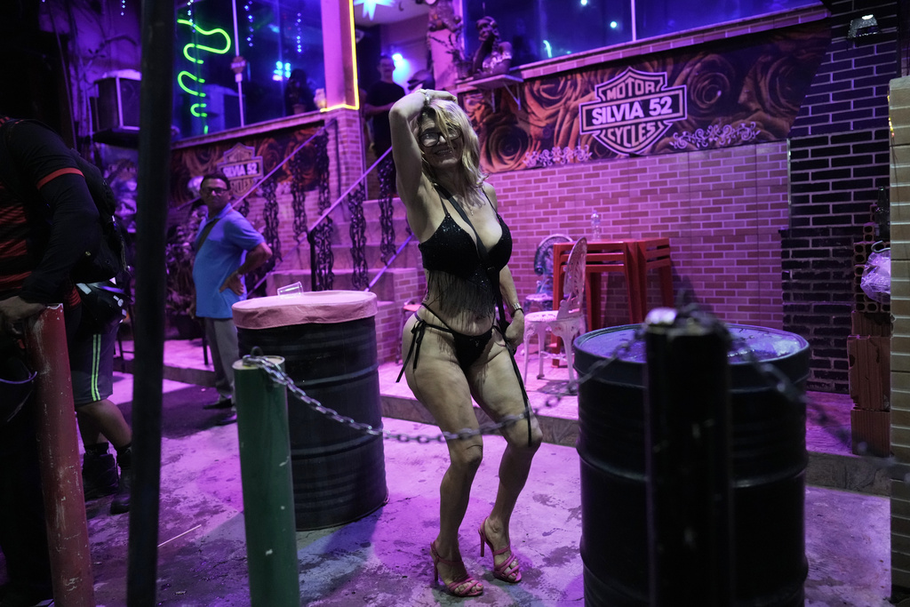 A sex worker dances during a pre-Carnival street party in the Vila Mimosa red-light district in Rio de Janeiro, Brazil, Friday, Feb. 6, 2026. (AP Photo/Silvia Izquierdo)