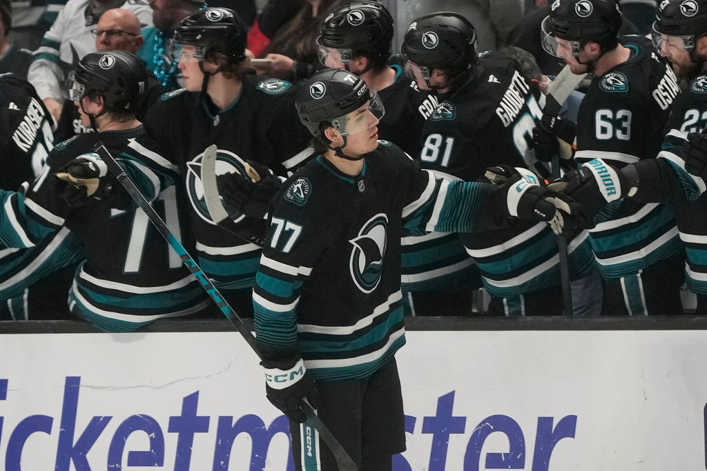 San Jose Sharks center Michael Misa (77) is congratulated by teammates after scoring against the Montréal Canadiens during the second period of an NHL hockey game in San Jose, Calif., Tuesday, March 3, 2026. (AP Photo/Jeff Chiu)