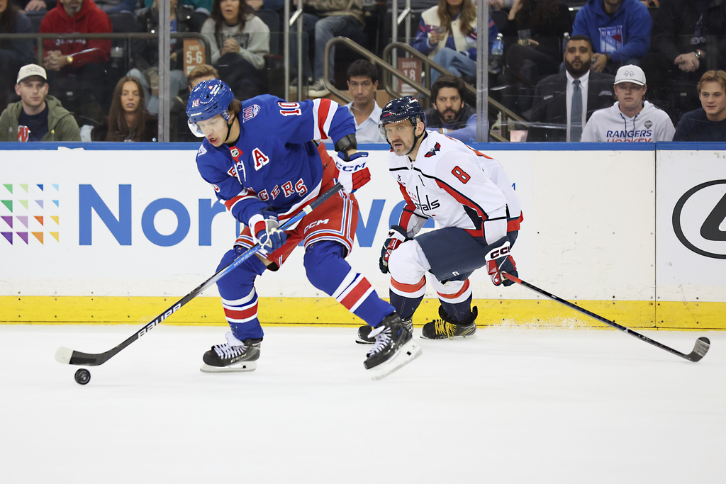 New York Rangers' Artemi Panarin (10) takes possession of the puck against Washington Capitals' Ovechkin (8) during the first period of an NHL hockey game, Sunday, Oct. 12, 2025, in New York. (AP Photo/Heather Khalifa)