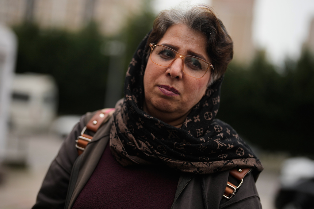 Sadri Haghshenas, a 47-year-old Iranian woman who works at a borek shop, walks in Istanbul on Tuesday, April 14, 2026. (AP Photo/Khalil Hamra)