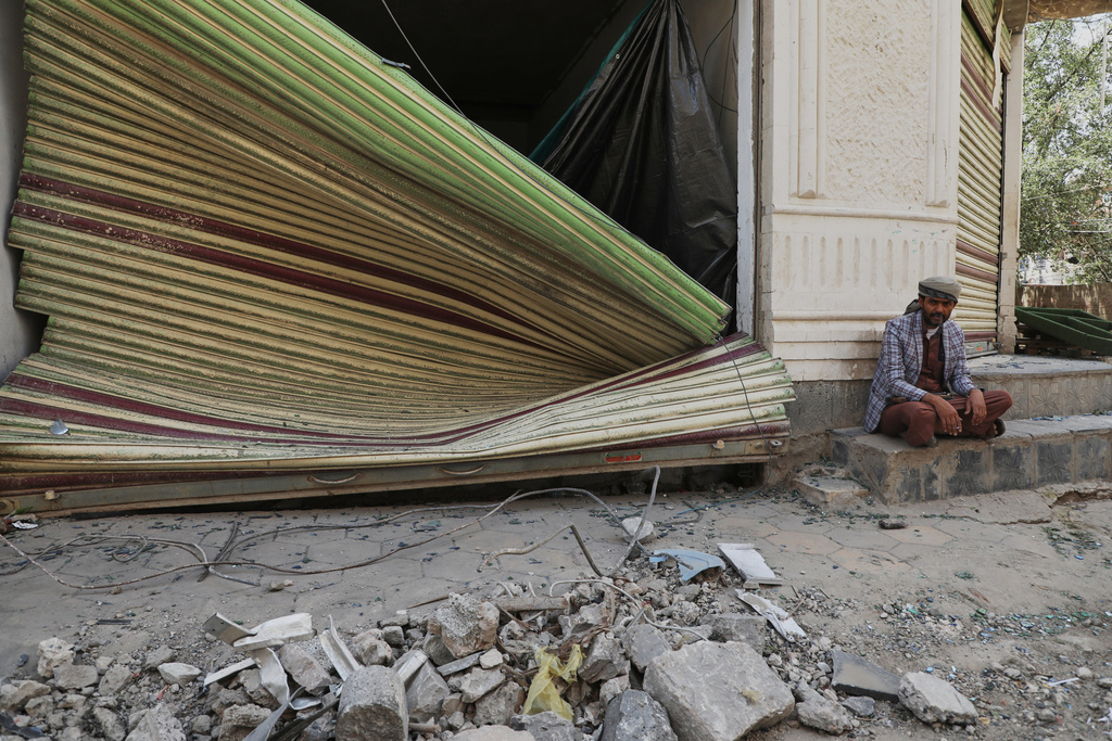 A man sets next to the debris of his damaged shop following Israeli airstrikes in Sanaa, Yemen, Friday, Sept. 26, 2025. (AP Photo)