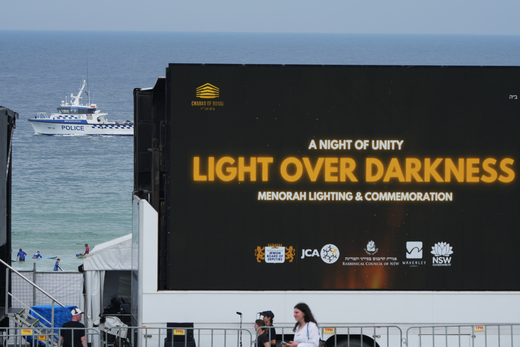 A police boat patrols Bondi Beach in Sydney, Sunday, Dec. 21, 2025, ahead of a ceremony to mark the National Day of Reflection for victims and survivors from the Bondi shooting on Dec. 14. (AP Photo/Mark Baker)