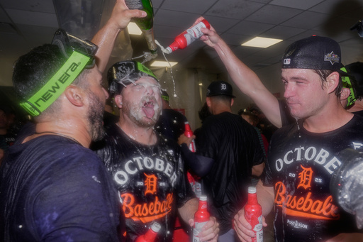 Detroit Tigers bullpen catcher Chris Chinea, left, catcher Jake Rogers, center, and catcher Dillon Dingler, right, celebrate in the locker room after defeating the Cleveland Guardians in Game 3 of an American League Wild Card baseball playoff series in Cleveland, Thursday, Oct. 2, 2025. (AP Photo/Sue Ogrocki) Detroit Tigers bullpen catcher Chris Chinea, left, catcher Jake Rogers, center, and catcher Dillon Dingler, right, celebrate in the locker room after defeating the Cleveland Guardians in Game 3 of an American League Wild Card baseball playoff series in Cleveland, Thursday, Oct. 2, 2025. (AP Photo/Sue Ogrocki)