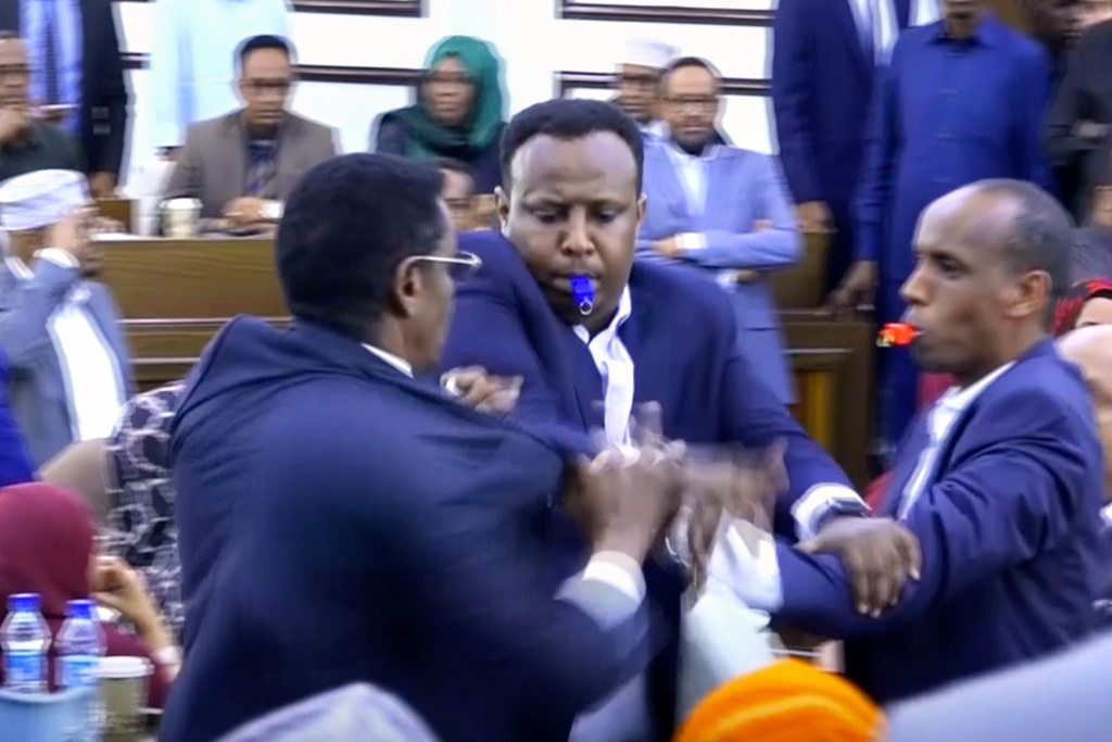 This image taken from an Associated Press video shows a scuffle between lawmakers during a joint session of Somalia's parliament Wednesday, Jan. 28, 2026, in Mogadishu, Somalia. (AP Photo/Mohamud Hassan)
