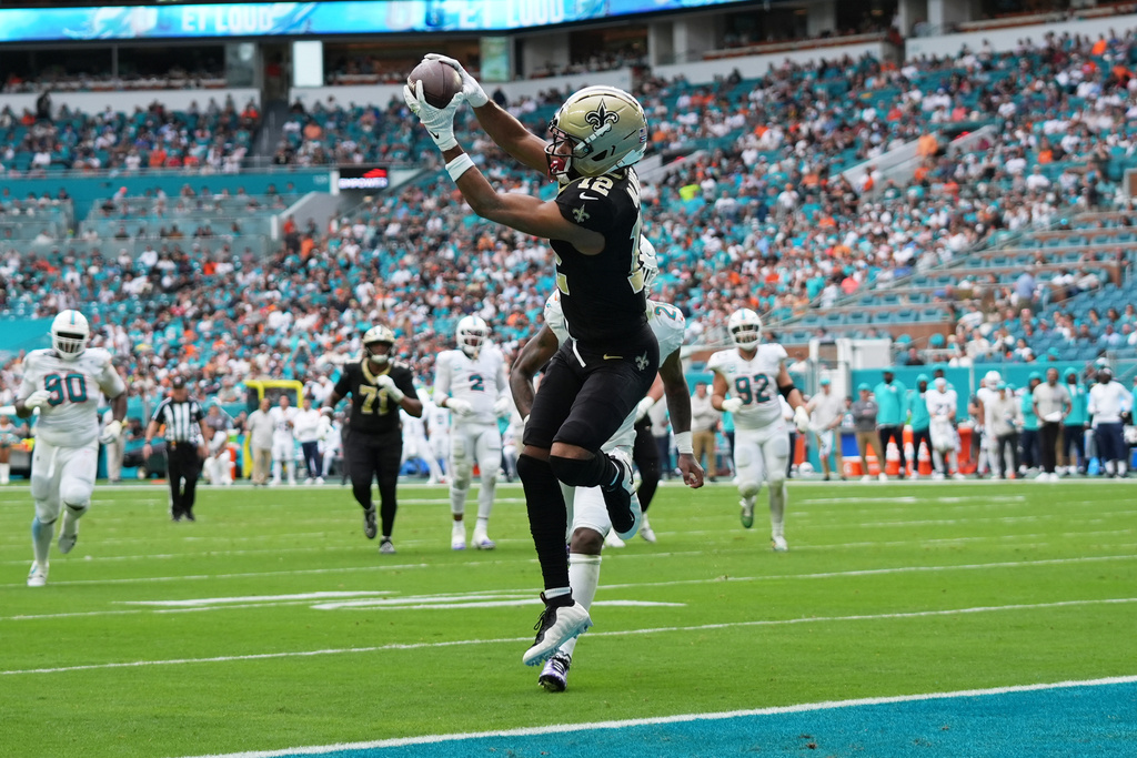 New Orleans Saints wide receiver Chris Olave (12) catches a pass for a touchdown during the second half of an NFL football game against the Miami Dolphins Sunday, Nov. 30, 2025, in Miami Gardens, Fla. (AP Photo/Lynne Sladky)
