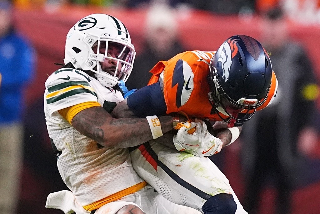 Green Bay Packers' Keisean Nixon tries to stop Denver Broncos' Troy Franklin during the second half of an NFL football game Sunday, Dec. 14, 2025, in Denver. (AP Photo/David Zalubowski)
