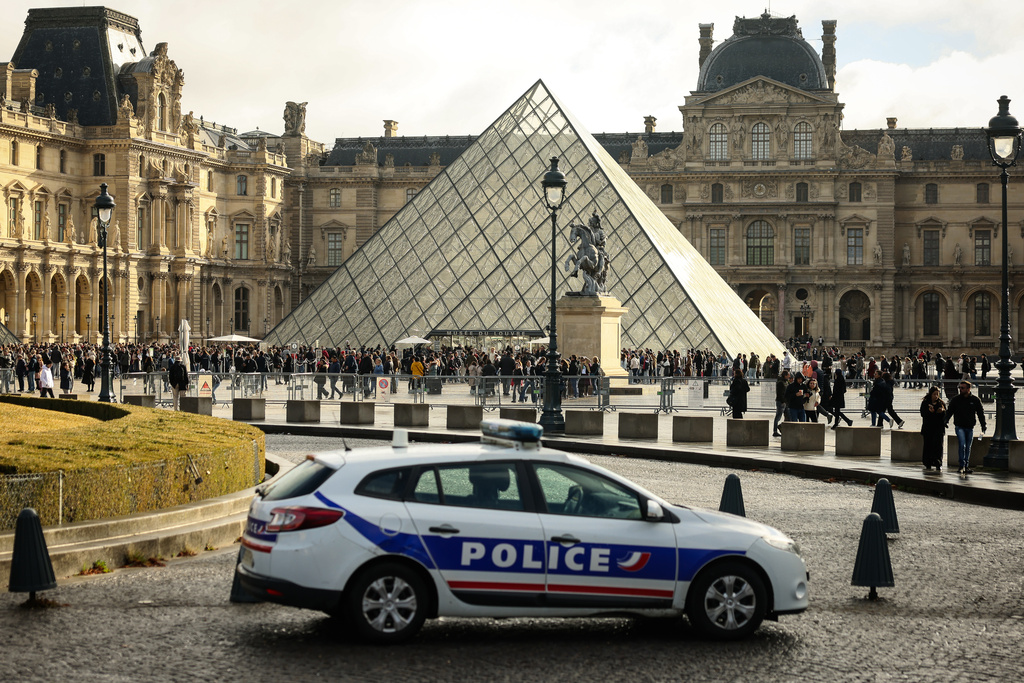 A police car parks in the courtyard of the Louvre museum, one week after the robbery, Sunday, Oct. 26, 2025 in Paris. The Paris prosecutor said on Sunday that a number of suspects have been arrested over the theft of crown jewels from Paris' Louvre museum last weekend. (AP Photo/Thomas Padilla)