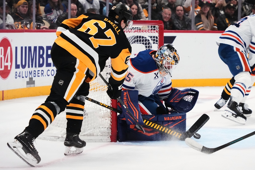 Edmonton Oilers goaltender Tristan Jarry blocks a shot by Pittsburgh Penguins' Rickard Rakell (67) during the second period of an NHL hockey game in Pittsburgh, Tuesday, Dec. 16, 2025. (AP Photo/Gene J. Puskar)