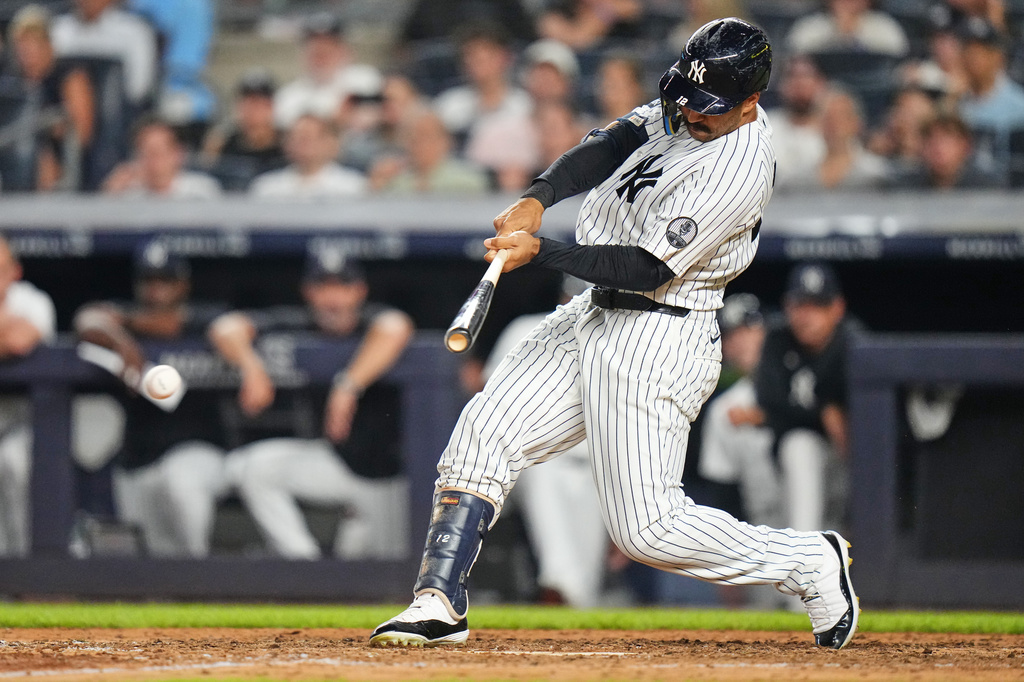 New York Yankees' Trent Grisham hits a two-run single during the seventh inning of a baseball game against the Seattle Mariners Tuesday, Aug. 11, 2026, in New York. (AP Photo/Frank Franklin II)