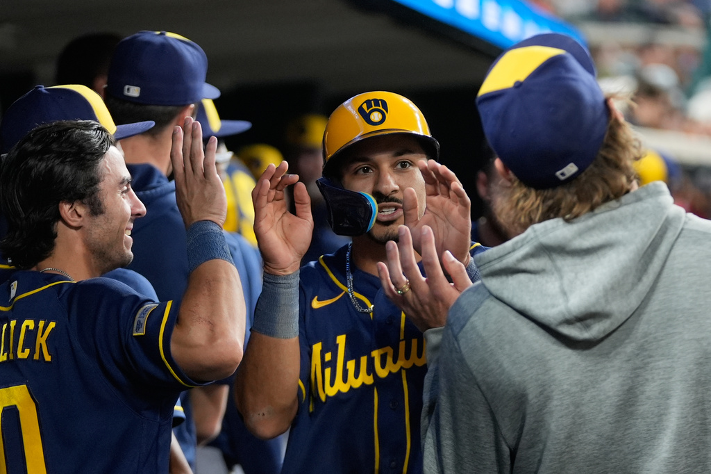 Milwaukee Brewers' David Hamilton (6) celebrates scoring against the Detroit Tigers during the seventh inning of a baseball game Tuesday, April 21, 2026, in Detroit. (AP Photo/Paul Sancya)