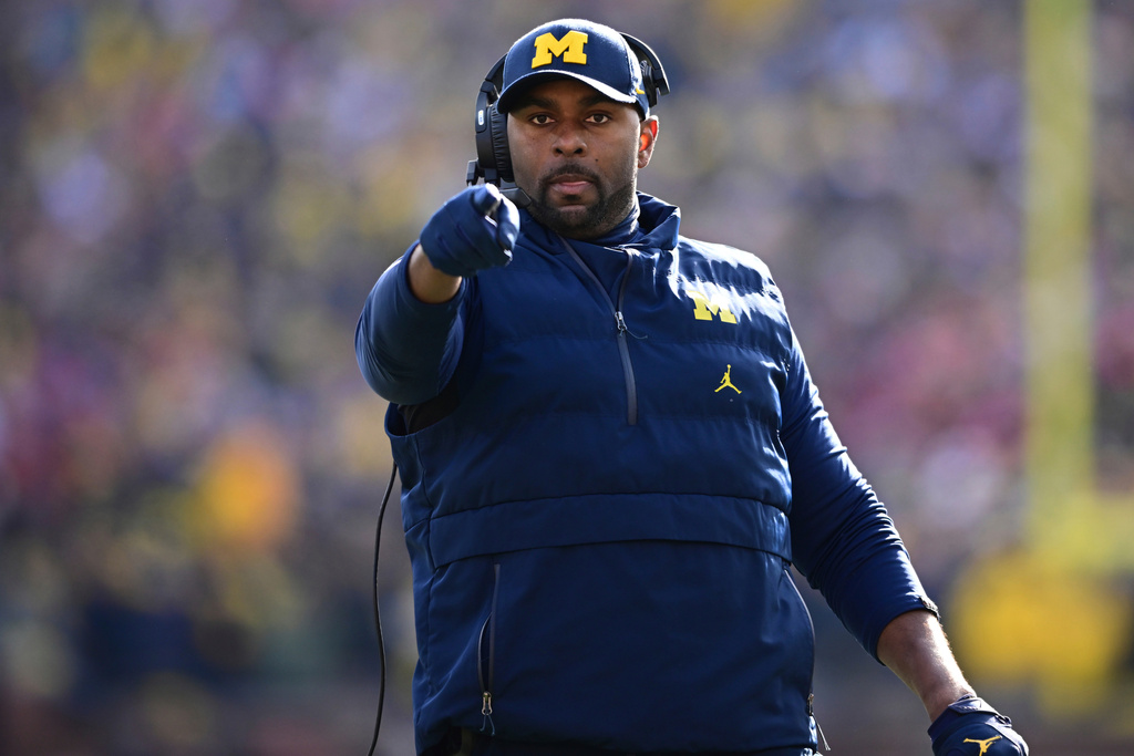 FILE - Michigan acting head coach Sherrone Moore reacts to a video replay during the first half of an NCAA college football game against Ohio State, Saturday, Nov. 25, 2023, in Ann Arbor, Mich. (AP Photo/David Dermer, File)