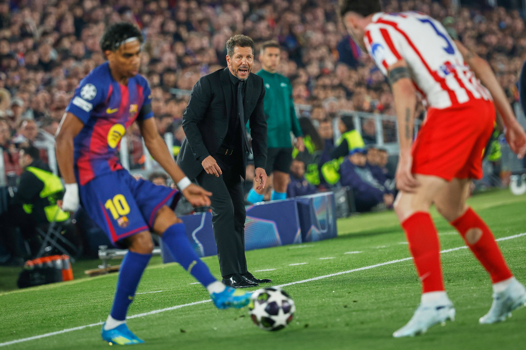 Atletico Madrid's head coach Diego Simeone, centre, reacts during the Champions League quarterfinal first leg soccer match between Barcelona and Atletico Madrid in Barcelona, Spain, Wednesday, April 8, 2026. (AP Photo/Joan Monfort)