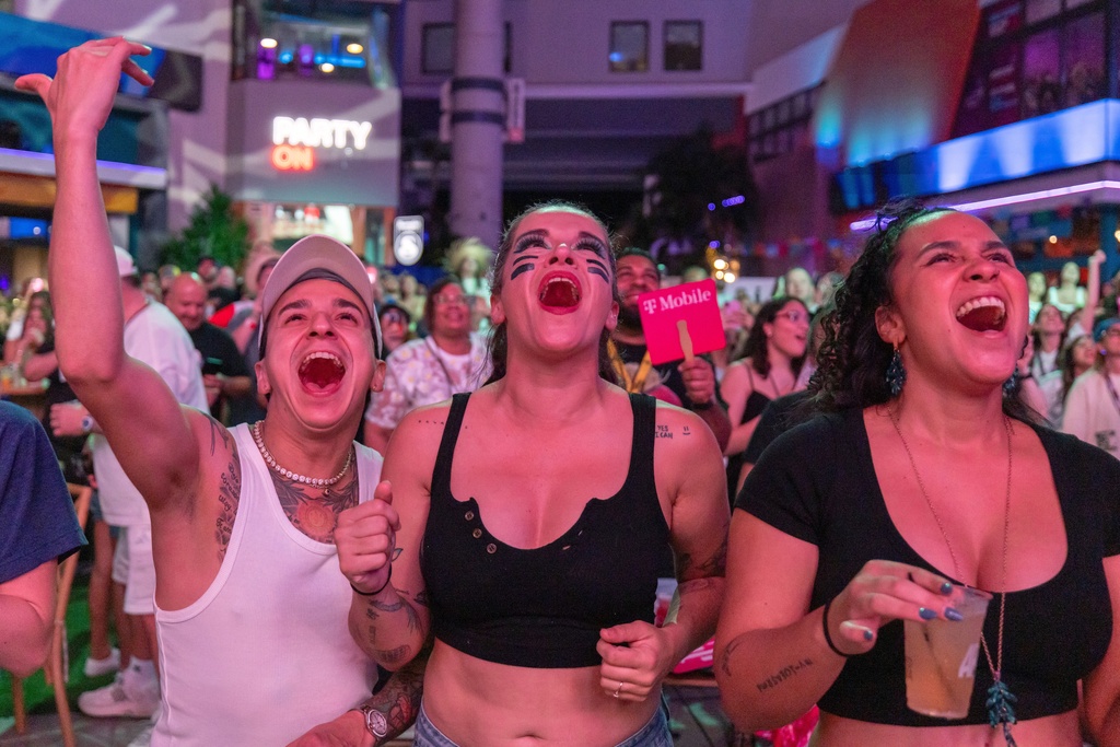 Fans in San Juan, Puerto Rico, watch Bad Bunny's performance on television during the halftime show of the NFL Super Bowl 60 football game Sunday, Feb. 8, 2026. (AP Photo/Alejandro Granadillo)