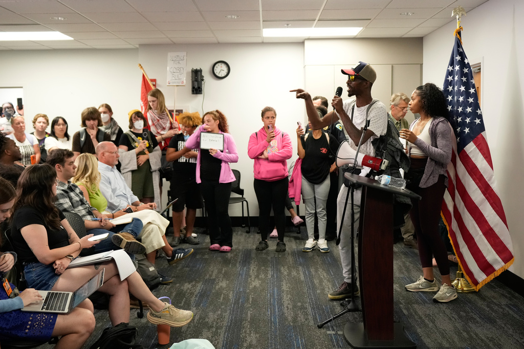Resident react during a press conference regarding the incident where a man was shot and killed on Wednesday by Madison police, Thursday, July 23, 2026, at the police station in Madison, Wis. (AP Photo/Kayla Wolf)