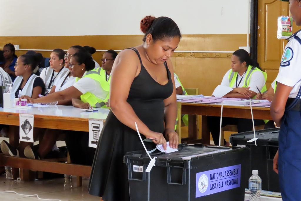 A woman casts her vote at English River School in Victoria, Seychelles, Thursday, Sept. 25, 2025. (AP Photo/Emilie Chetty)