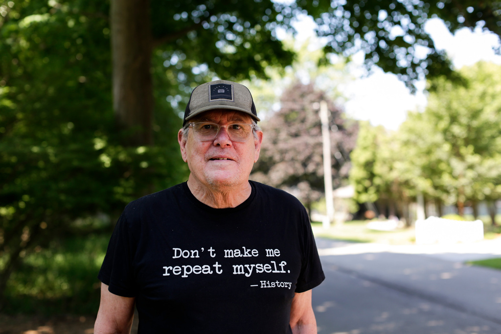 Dave Burdick, a supporter of Democratic Senate candidate Abdul El-Sayed, stands for a portrait outside of his home in Douglas, Mich., on Tuesday, July 7, 2026. (AP Photo/Kristen Norman)