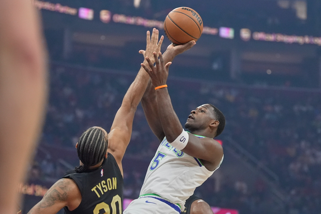 Minnesota Timberwolves guard Anthony Edwards (5) shoots as Cleveland Cavaliers guard Jaylon Tyson (20) defends in the first half of an NBA basketball game, Monday, Oct. 26, 2026, in Cleveland. (AP Photo/Sue Ogrocki)