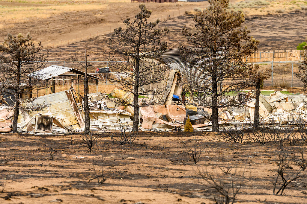 A scorched structure is seen following the Bug Fire near Reno, Nev., Thursday, Aug. 13, 2026. (AP Photo/Noah Berger)