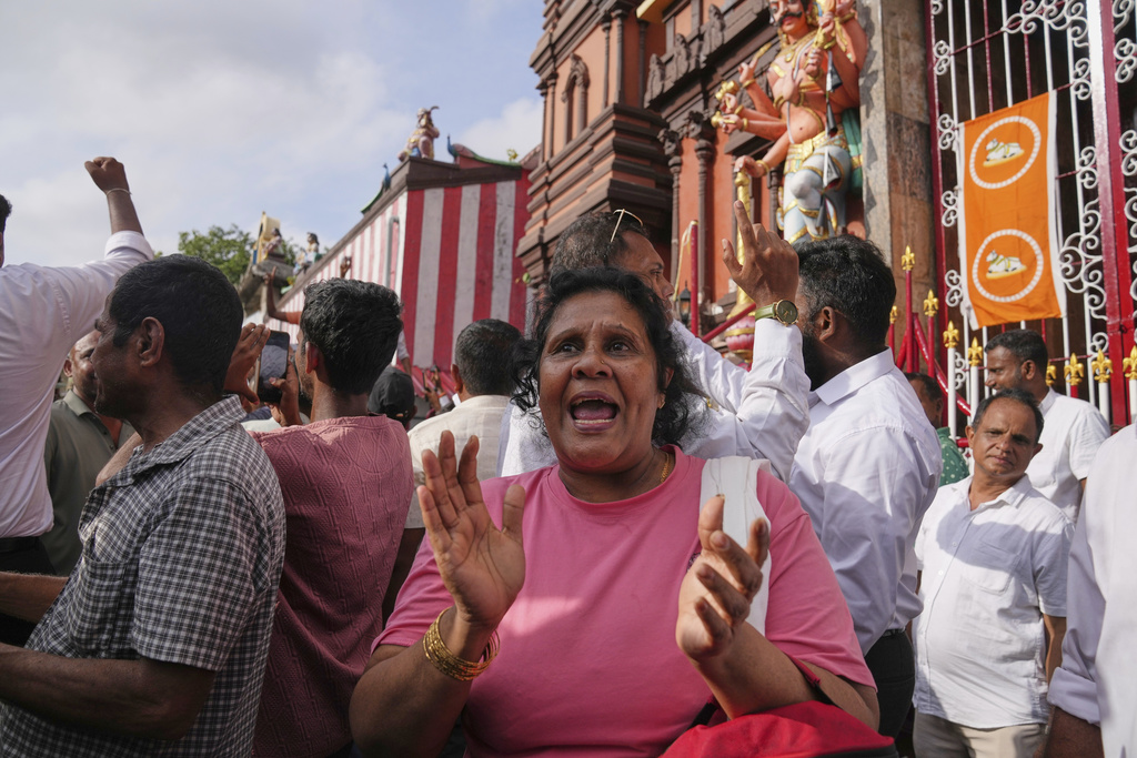 Supporters of former president of Sri Lanka Ranil Wickremesinghe celebrate after a court granted him bail, in Colombo, Sri Lanka, Tuesday, Aug. 26, 2025. (AP Photo/Eranga Jayawardena)