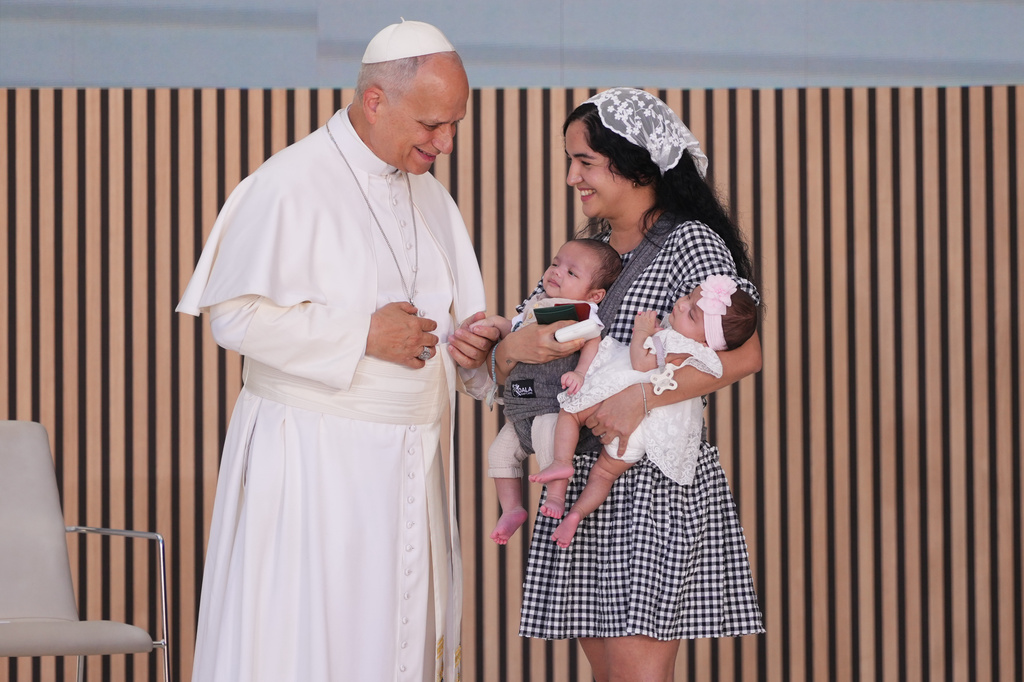 Pope Leo XIV talks to Niurka, a mother of two, during his visit to the CEDIA 24 Horas Social Project center in Madrid, Saturday, June 6, 2026, on the first day of a seven-day apostolic journey to continental Spain and Canary Islands. (AP Photo/Alessandra Tarantino)