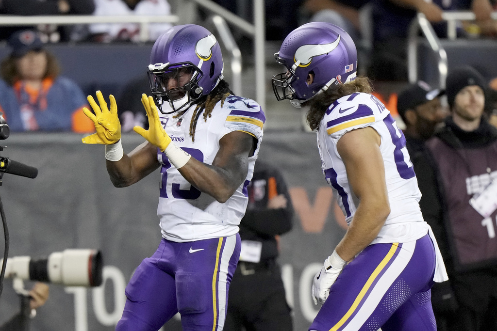 Minnesota Vikings running back Aaron Jones Sr., left, celebrates after scoring as teammate T.J. Hockenson (87) watches during the second half of an NFL football game against the Chicago Bears Monday, Sept. 8, 2025, in Chicago. (AP Photo/Nam Y. Huh)