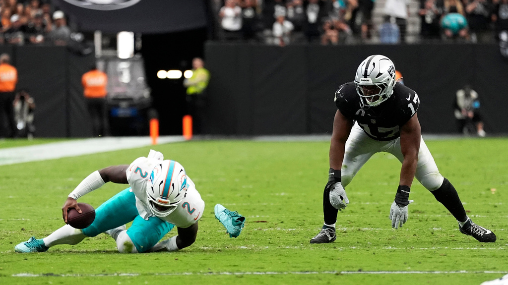 Miami Dolphins quarterback Malik Willis (2) is sacked by Las Vegas Raiders linebacker Nakobe Dean (17) during the second half of an NFL football game, Sunday, Sept. 13, 2026, in Las Vegas. (AP Photo/Ross D. Franklin)