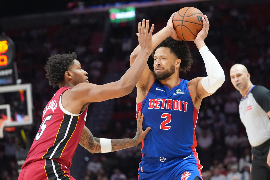 Detroit Pistons guard Cade Cunningham (2) looks to pass the ball as Miami Heat forward Myron Gardner (15) defends during the first half of an NBA basketball game Sunday, March 8, 2026, in Miami. (AP Photo/Marta Lavandier)