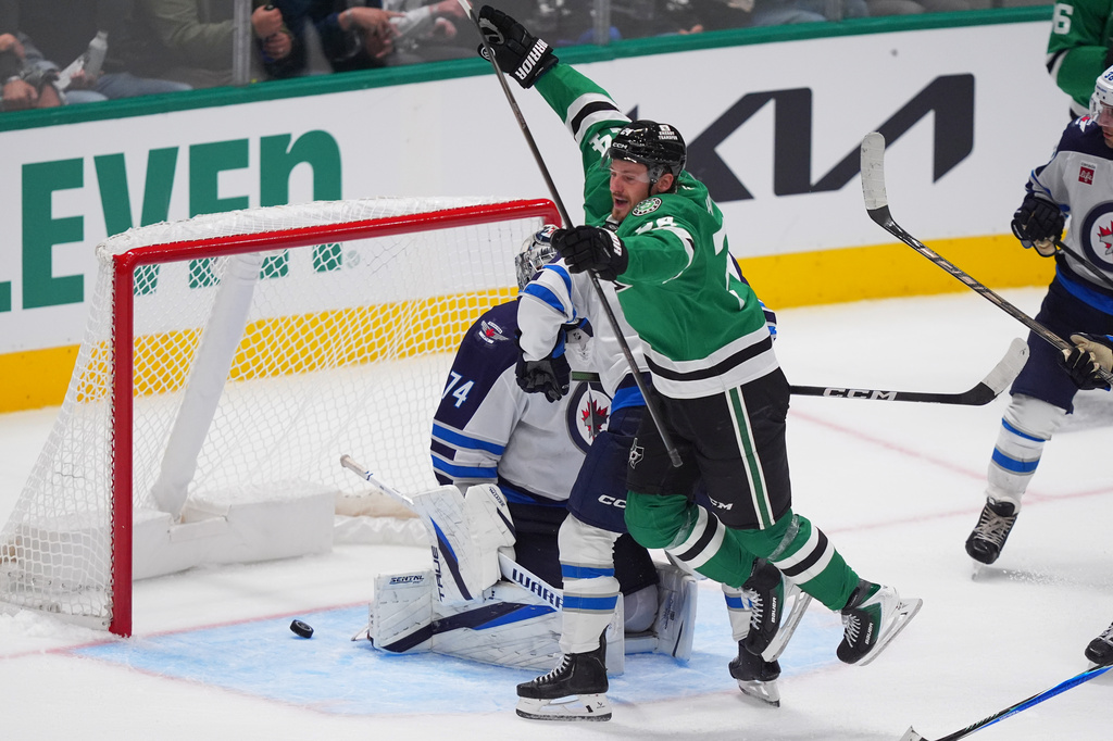 Dallas Stars center Roope Hintz (24) jumps after scoring a goal against Winnipeg Jets goaltender Stuart Skinner (74) during the third period of an NHL hockey game Thursday, Oct. 22, 2026, in Dallas. (AP Photo/LM Otero)