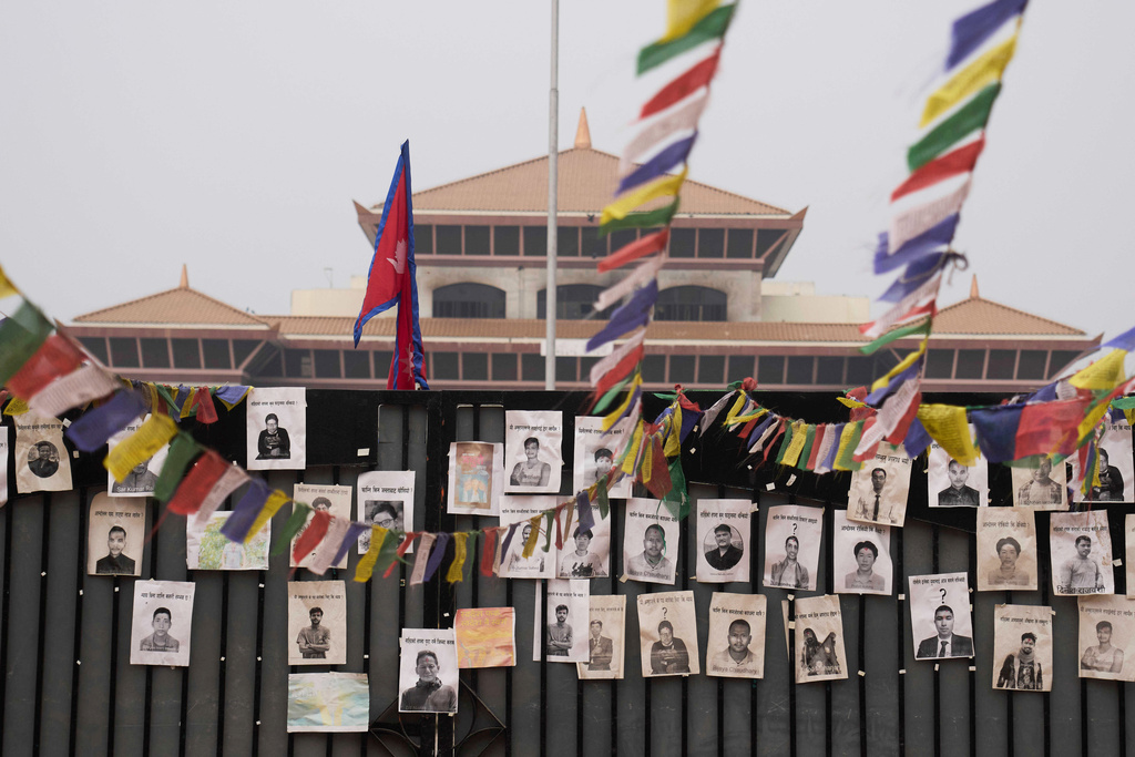 Photos of people who died in last year's deadly anti-corruption Gen Z protest are placed on the gate of the parliament building in Kathmandu, Nepal, Sunday, March 8, 2026. (AP Photo/Niranjan Shrestha)