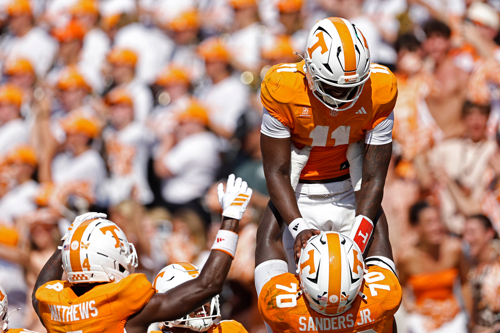 Tennessee quarterback Faizon Brandon (11) is lifted up by offensive lineman David Sanders Jr. (70) as they celebrate a touchdown during the first half of an NCAA college football game against Furman, Saturday, Sept. 5, 2026, in Knoxville, Tenn. (AP Photo/Wade Payne)