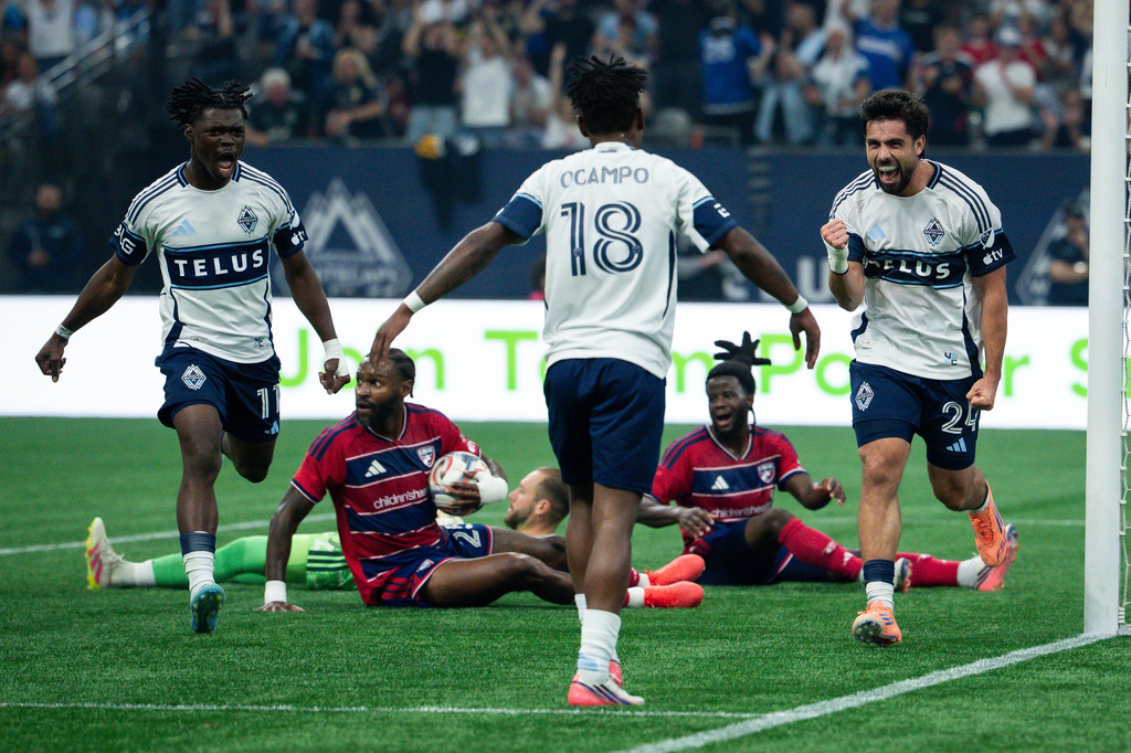Vancouver Whitecaps' Brian White (24) celebrates his goal against FC Dallas with Edier Ocampo (18) and Emmanuel Sabbi (11) during the first half of an MLS soccer match in Vancouver, British Columbia, Saturday, Aug. 22, 2026. (Ethan Cairns/The Canadian Press via AP)