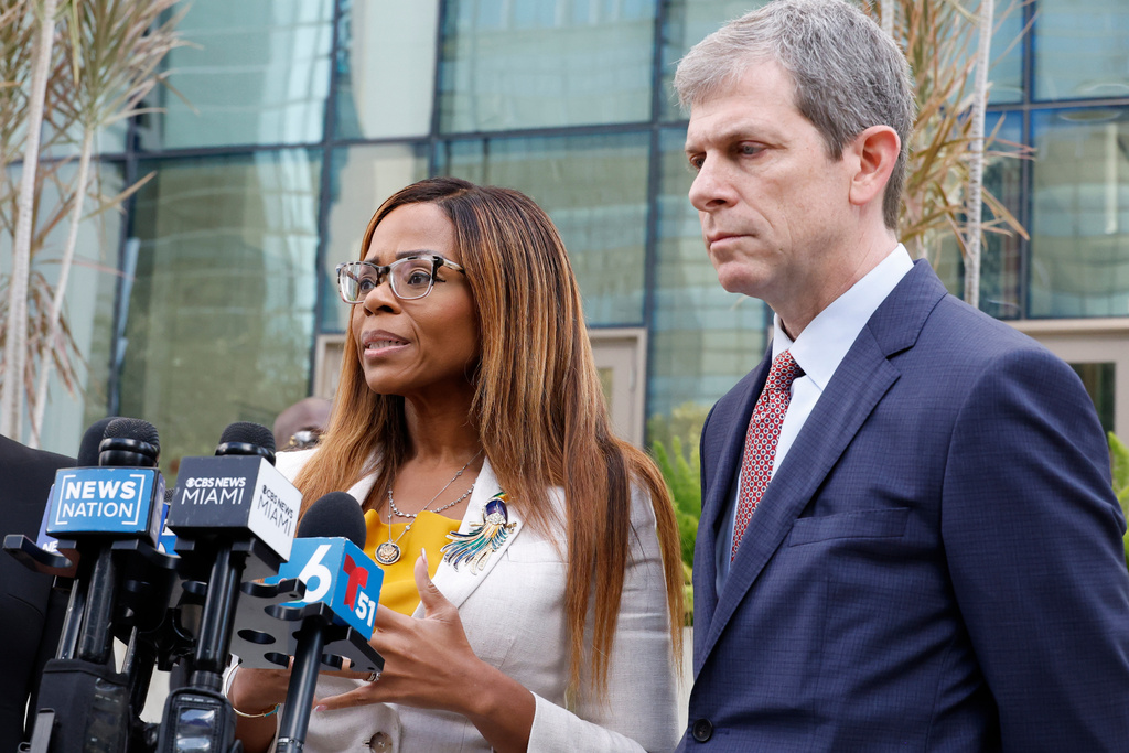 CORRECTS TO HEARING, NOT ARRAIGNMENT - U.S. Rep. Sheila Cherfilus-McCormick, D-Fla., left, speaks to the media as her lawyer David Markus looks on after a hearing in federal court Monday, Dec. 29, 2025 in Miami. (AP Photo/Terry Renna)