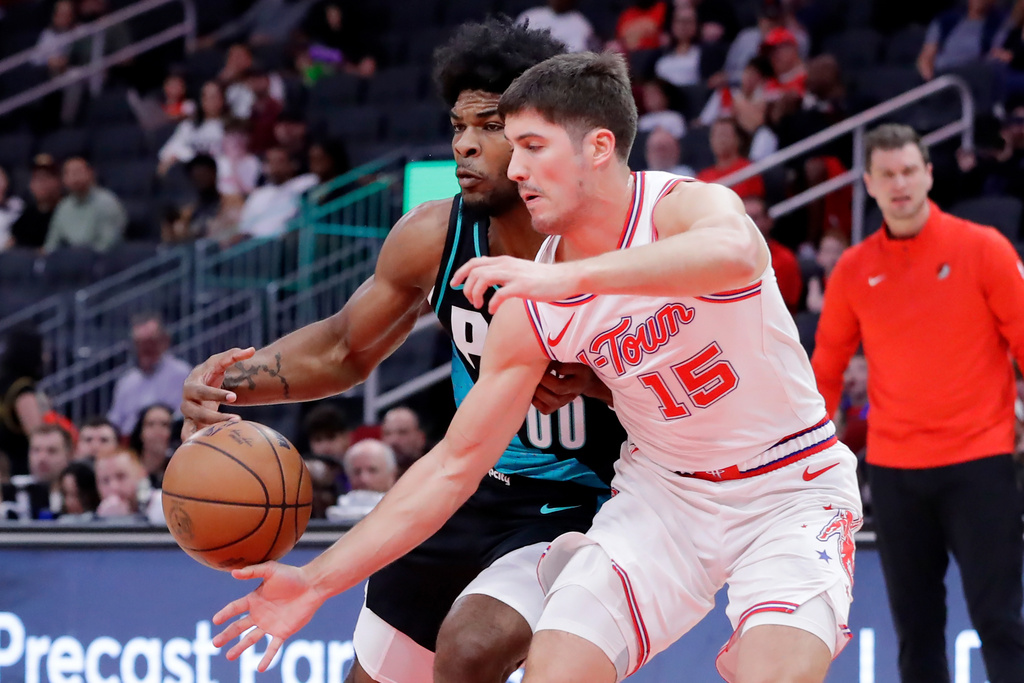 Houston Rockets guard Reed Sheppard (15) knocks away the ball from Portland Trail Blazers guard Scoot Henderson (00) during the first half of an NBA basketball game Friday March 6, 2026, in Houston. (AP Photo/Michael Wyke)