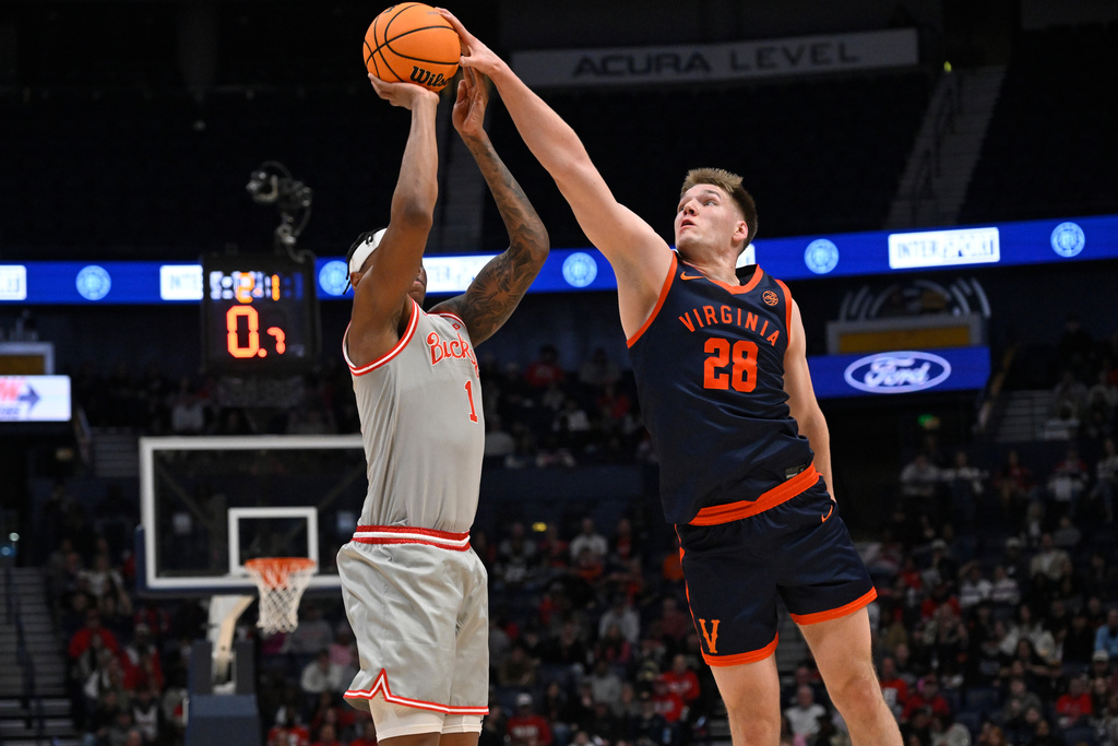 Virginia forward Thijs de Ridder (28) blocks a shot by Ohio State forward Amare Bynum (1) during the first half of an NCAA college basketball game Saturday, Feb. 14, 2026, in Nashville, Tenn. (AP Photo/John Amis)