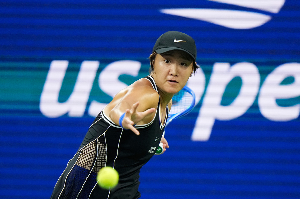 FILE - Wang Xiyu, of China, returns the ball to Iga Swiatek, of Poland, during the first round of the U.S. Open tennis championships on Aug. 31, 2026, in New York. (AP Photo/Frank Franklin II, File)