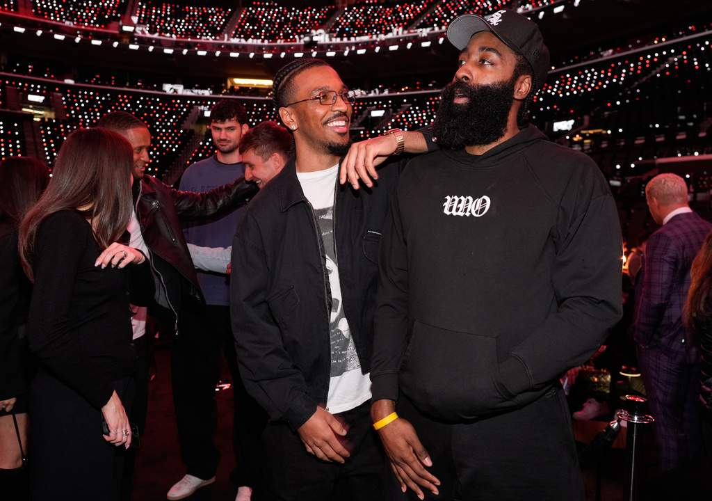NFL quarterback Jayden Daniels, center, and NBA player James Harden mingle at the launch party for Fanatics Studio, a global studio for sports entertainment, on Tuesday, Jan. 13, 2026, at the Intuit Dome in Inglewood, Calif. (AP Photo/Chris Pizzello)