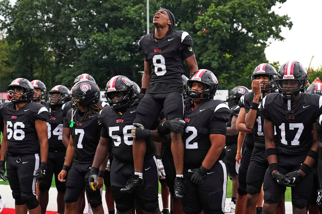 CORRECTS FIRST NAME TO AKIVA FROM AKIRA - Aliquippa Senior running back Akiva Woods (8) leads a pre-game cheer with teammates before a high school football game between Aliquippa and Mars high schools at Heinz Field in Aliquippa, Pa., Friday, Sept. 4, 2026. (AP Photo/Gene J. Puskar)