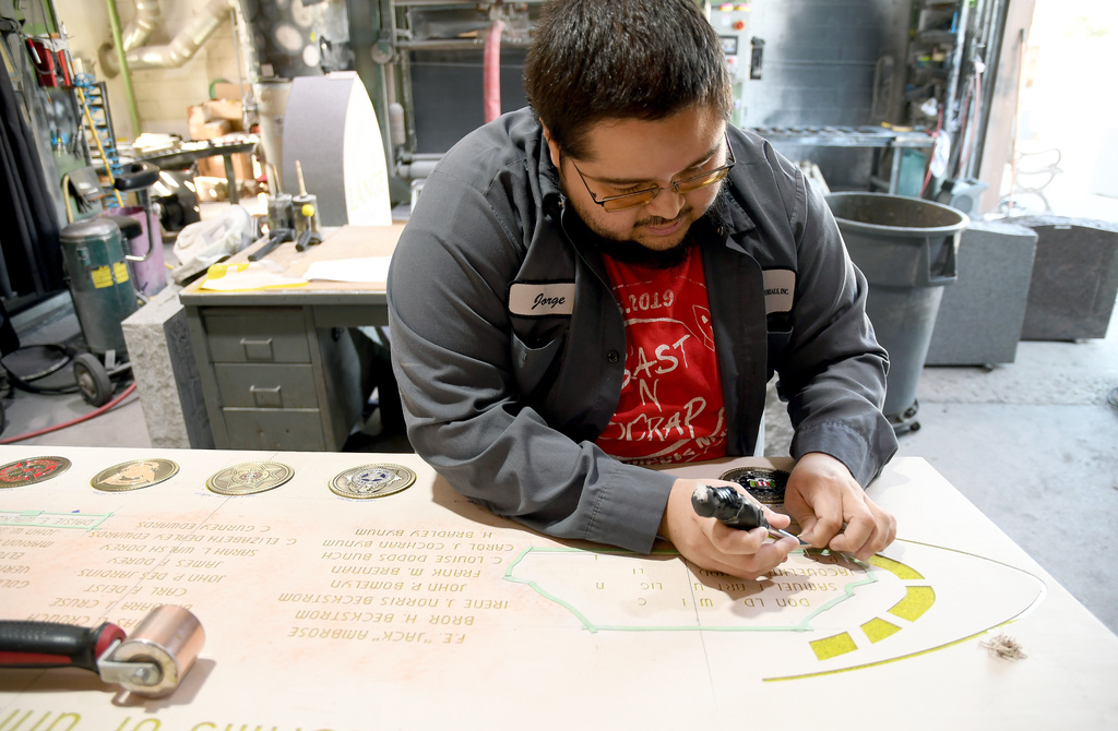 Jorge Arredondo works on the United Air Lines Flight 629 memorial in Greeley, Colo., Wednesday, Oct. 15, 2025. (AP Photo/Thomas Peipert)