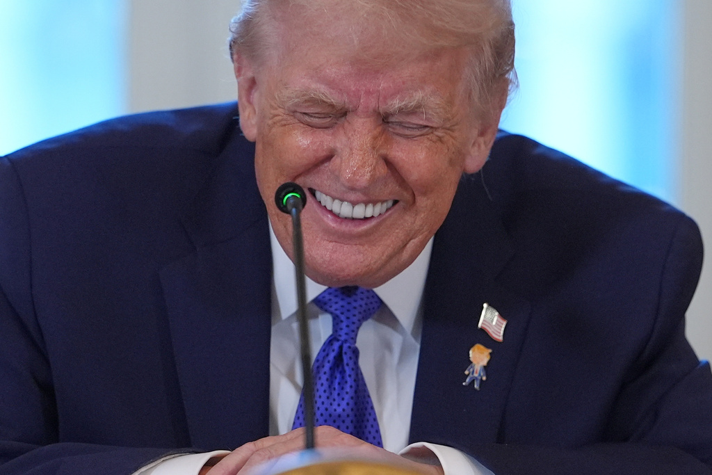 President Donald Trump laughs during a meeting with oil executives in the East Room of the White House, Friday, Jan. 9, 2026, in Washington. (AP Photo/Evan Vucci)