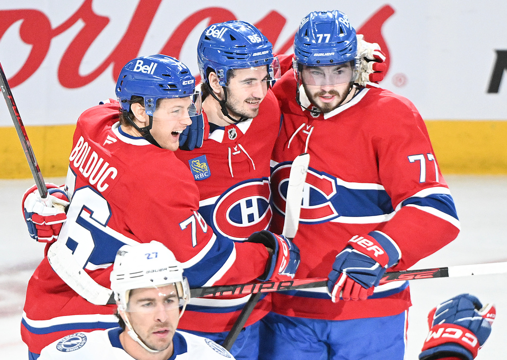 Montreal Canadiens' Kirby Dach (77) celebrates with teammates Zachary Bolduc (76) and Alexandre Texier (85) after scoring against the Tampa Bay Lightning during the second period of Game 3 in a first-round NHL hockey Stanley Cup playoff series in Montreal, Friday, April 24, 2026. (Graham Hughes/The Canadian Press via AP)