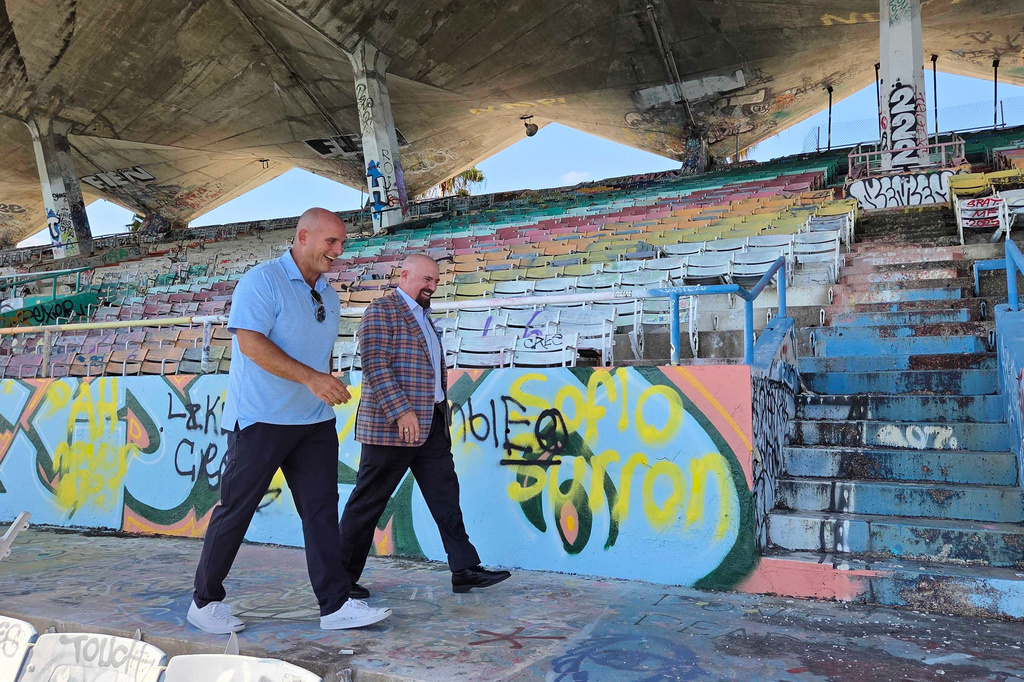 Breakwater Hospitality Group co-founder Emi Guerra, left, and Miami Commissioner Damian Pardo walk through the Miami Marine Stadium on Tuesday, Aug. 11, 2026, in Miami. (AP Photo/David Fischer)